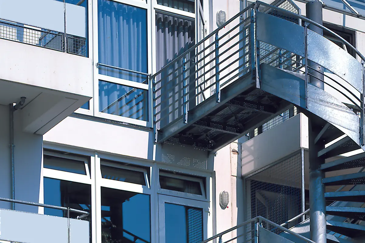 Windows and a metal staircase on the outside of a modern building
